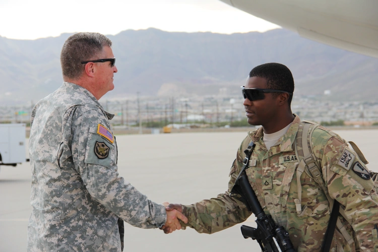 U.S. Army personnel meeting on the flightline at a forward operating location
